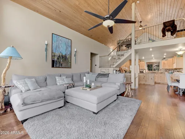 a living room with furniture and a wooden floor