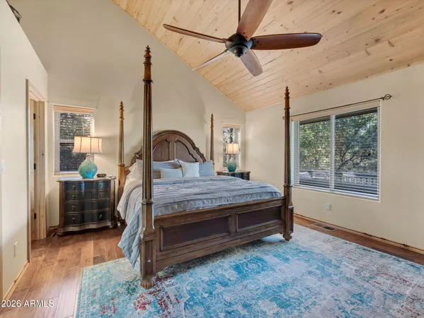 a bedroom with a bed a large window with outer view