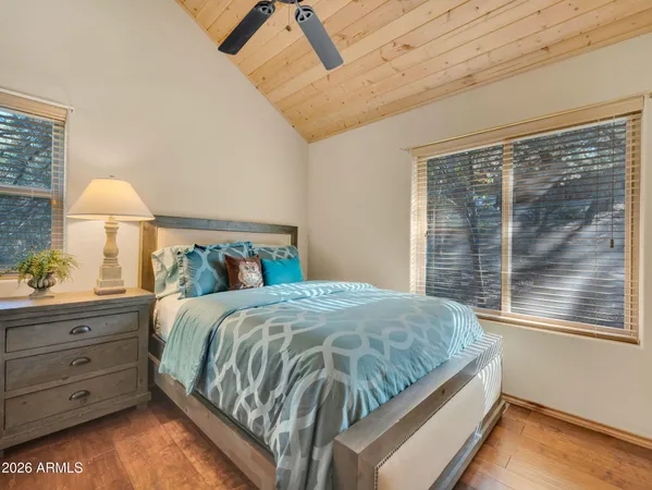 a bed sitting in a bedroom next to a window