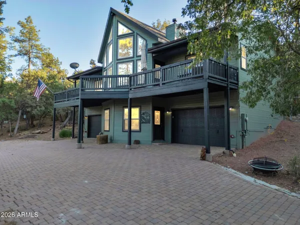 a view of a house with a patio and a yard