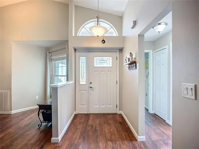 a kitchen with kitchen island granite countertop a sink dishwasher stove and cabinets