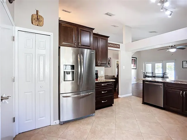 a bathroom with a granite countertop sink toilet and a mirror
