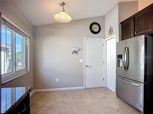 a bathroom with a granite countertop sink a toilet and mirror