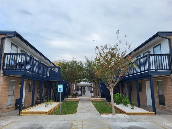 a view of a building with a yard