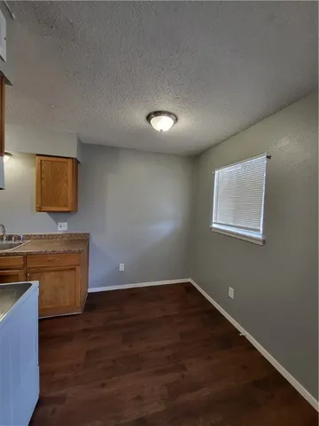 a view of room with wooden floor and fan