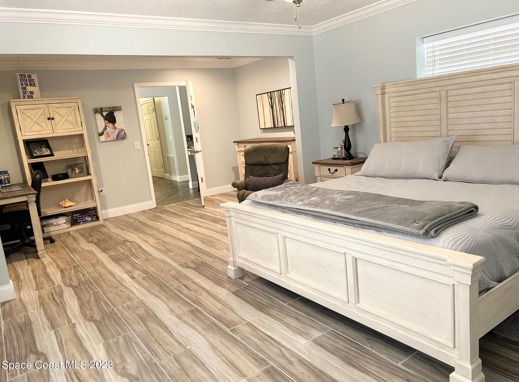 1639 Emmaus Road Northwest Palm Bay, FL 32907 - Photo 13 of 40 a bedroom with a bed and a television