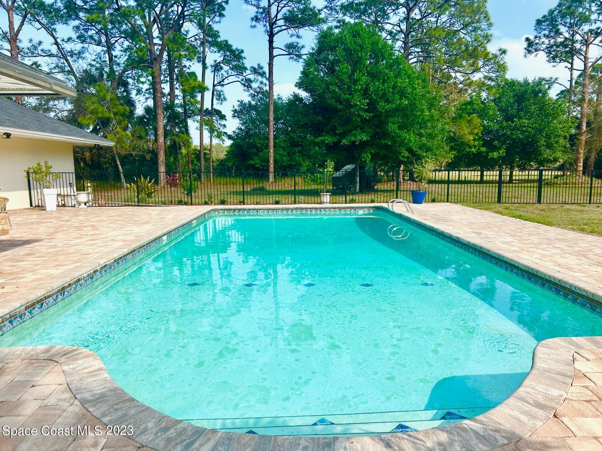 1639 Emmaus Road Northwest Palm Bay, FL 32907 - Photo 18 of 40 a view of a swimming pool with a patio