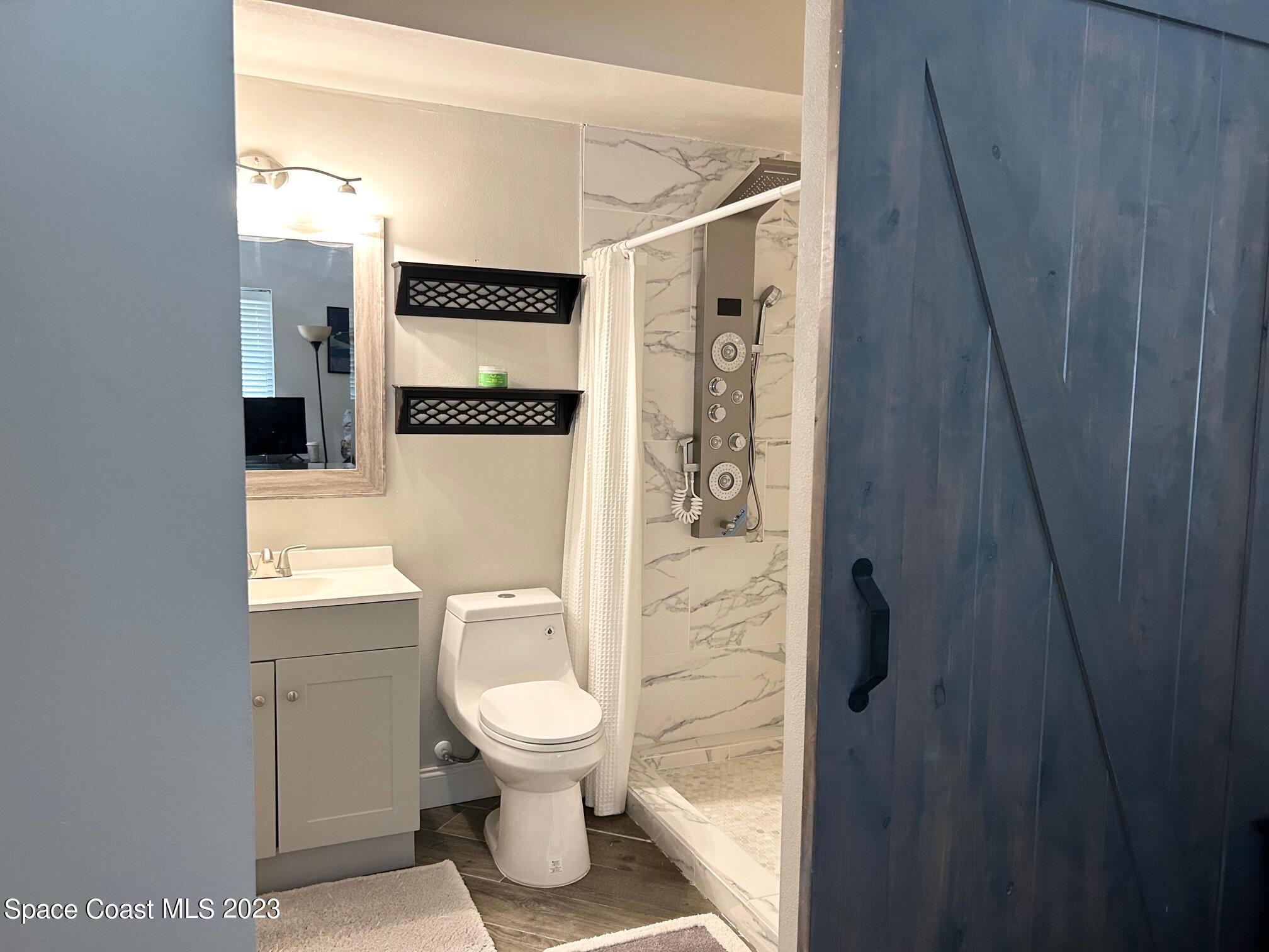 1639 Emmaus Road Northwest Palm Bay, FL 32907 - Photo 33 of 40 a bathroom with a toilet and a shower