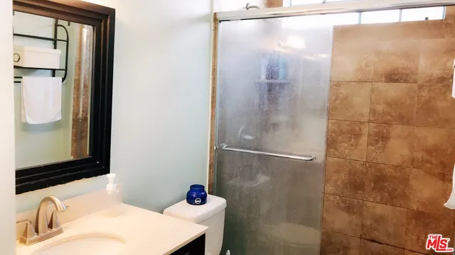a bathroom with a sink and shower