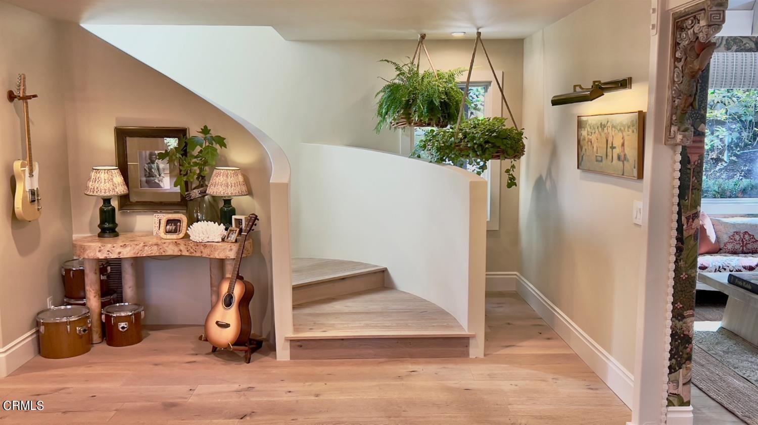 2460 Valley Meadow Drive Oak View, CA 93022 - Photo 8 of 49 a view of a hallway with wooden floor and a potted plant