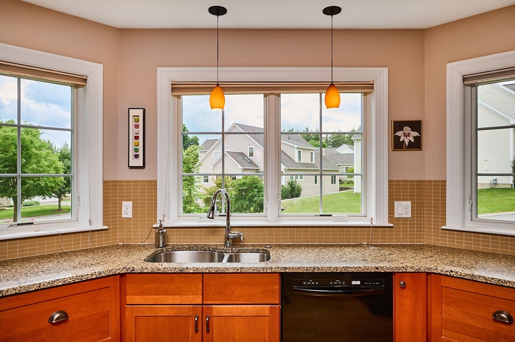 20 Bridge Road, Unit 18 Northampton, MA 01062 - Photo 12 of 42 a kitchen with granite countertop sink and window