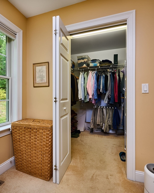 20 Bridge Road, Unit 18 Northampton, MA 01062 - Photo 17 of 42 a view of walk in closet with clothes and shoes