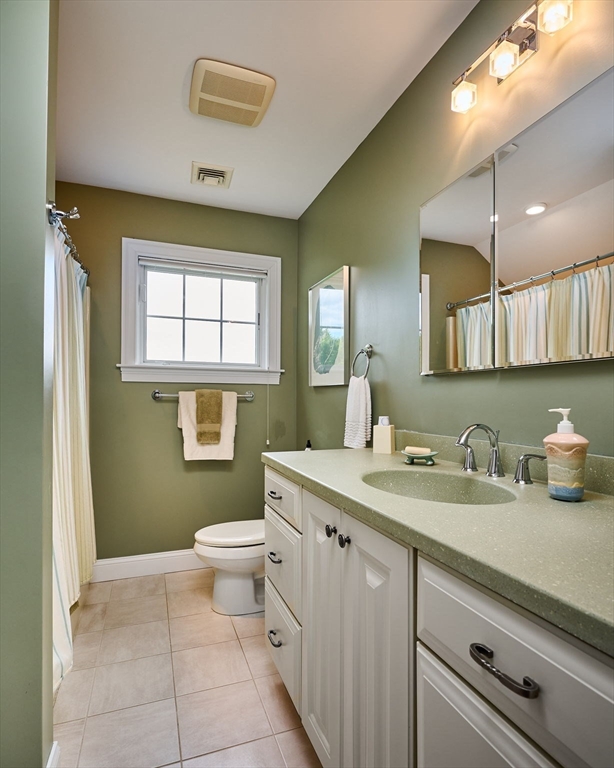 20 Bridge Road, Unit 18 Northampton, MA 01062 - Photo 26 of 42 a spacious bathroom with a granite countertop sink a toilet and a mirror