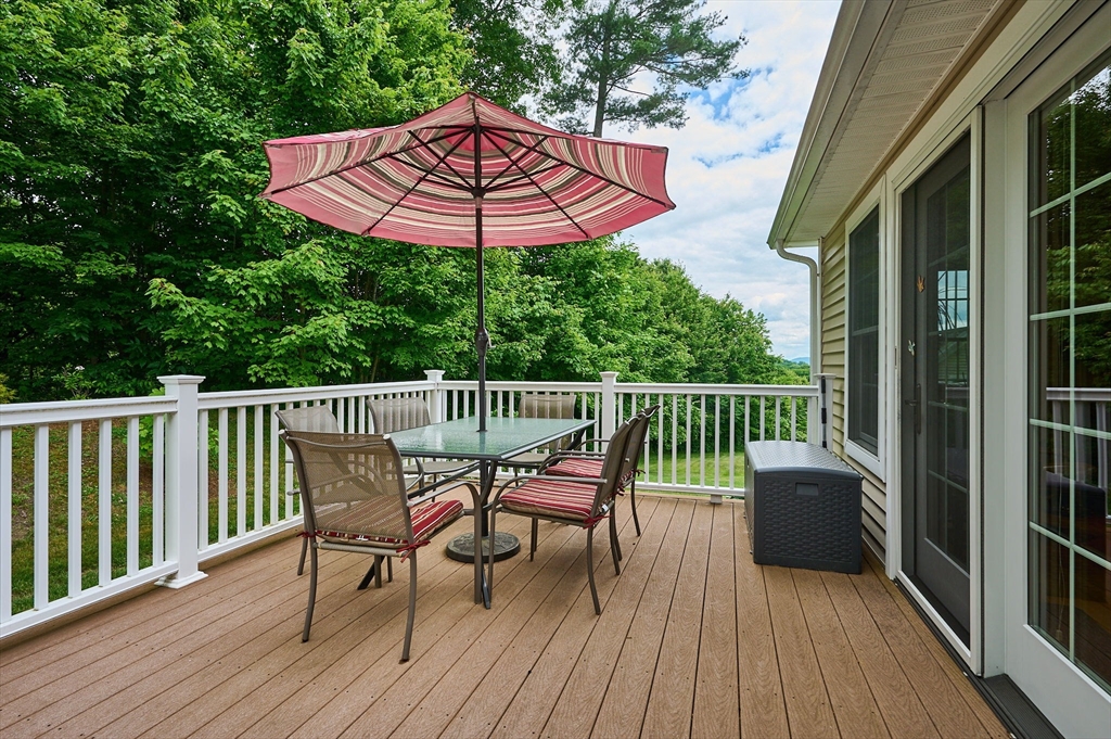 20 Bridge Road, Unit 18 Northampton, MA 01062 - Photo 33 of 42 a view of a wooden deck with furniture