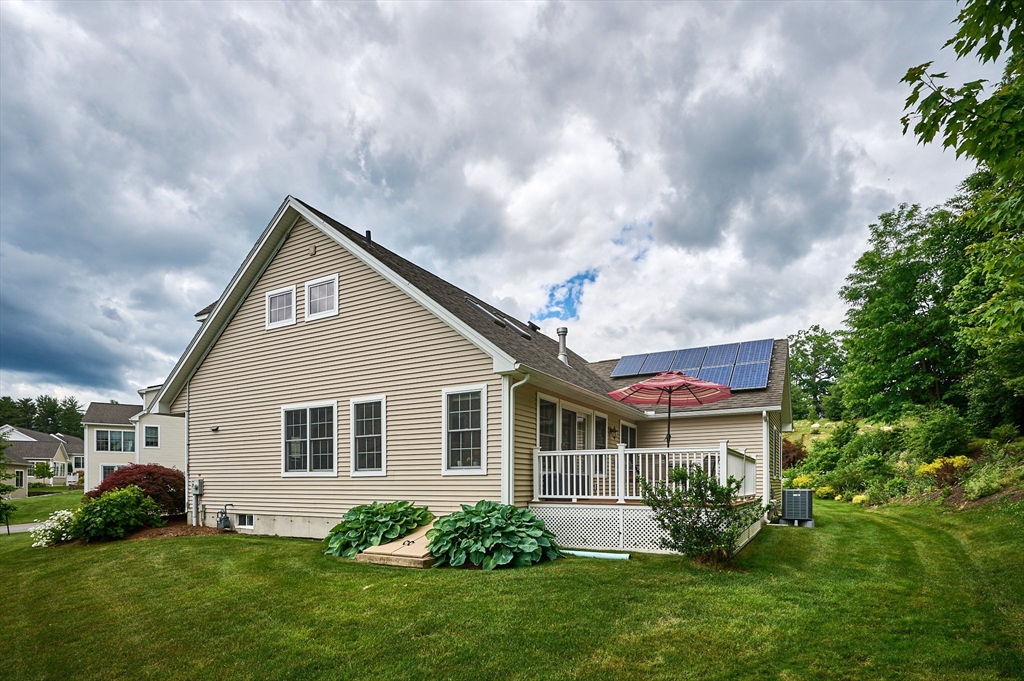 20 Bridge Road, Unit 18 Northampton, MA 01062 - Photo 34 of 42 a front view of a house with a garden and plants