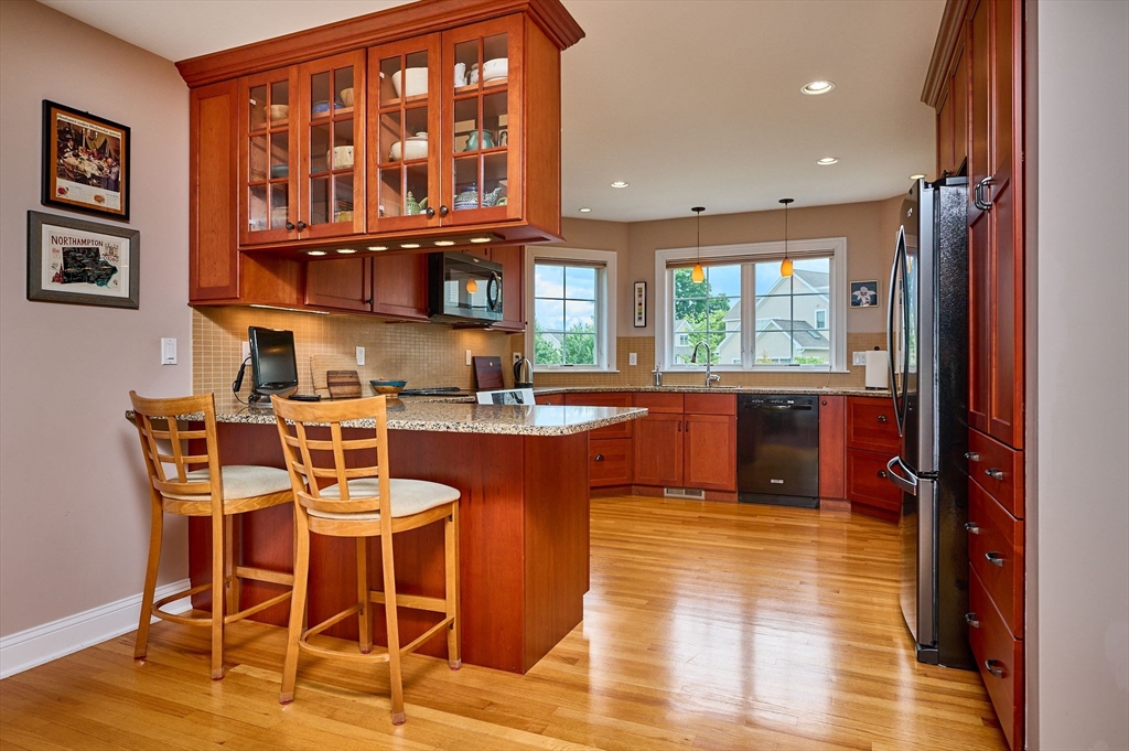 20 Bridge Road, Unit 18 Northampton, MA 01062 - Photo 10 of 42 a kitchen with a dining table chairs and cabinets