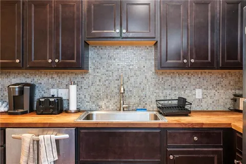 a kitchen with a sink a stove and cabinets