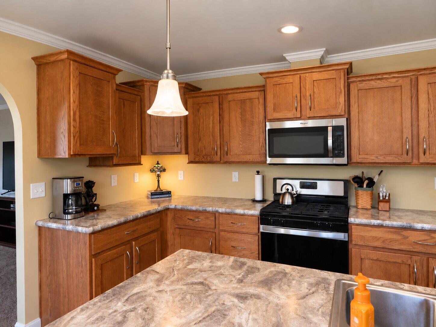 338 Marshfield Flats Road Marshfield, ME 04654 - Photo 5 of 26 Warm Oak Kitchen with Matte Microwave