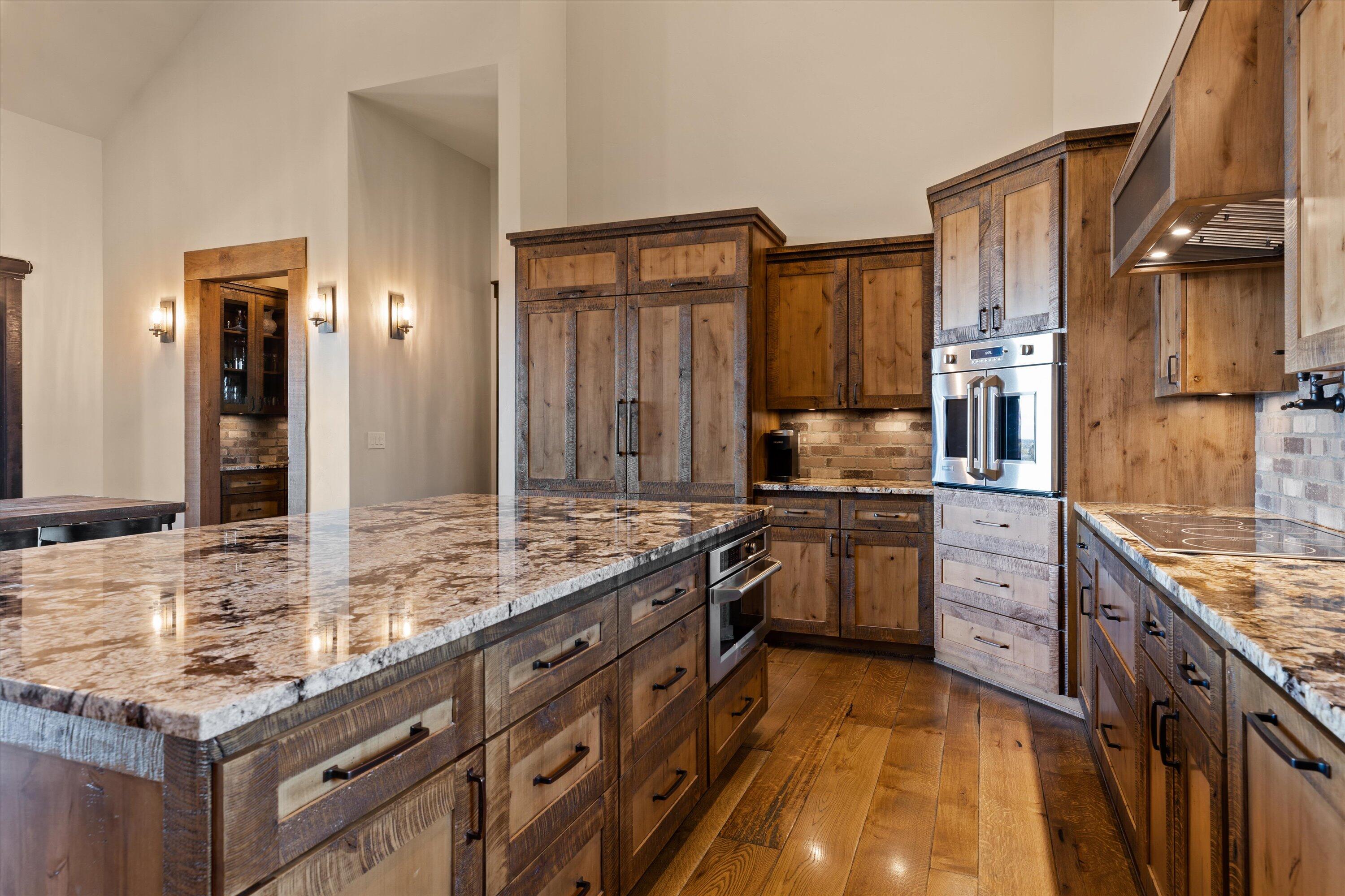 15626 South W Brasada Ranch Road Powell Butte, OR 97753 - Photo 26 of 81 a kitchen with stainless steel appliances granite countertop a stove sink and cabinets