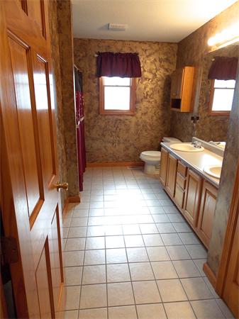 22 Dunbar Street Springfield, MA 01118 - Photo 12 of 21 a bathroom with a toilet a sink a mirror and a shower