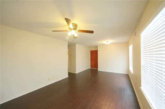 wooden floor in an empty room with a window