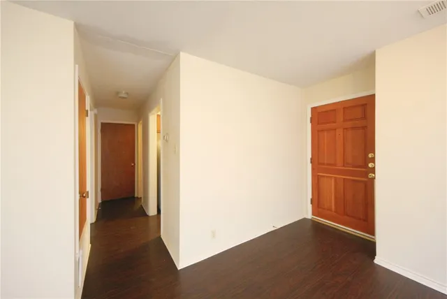 a view of a room with walk in closet and wooden floor