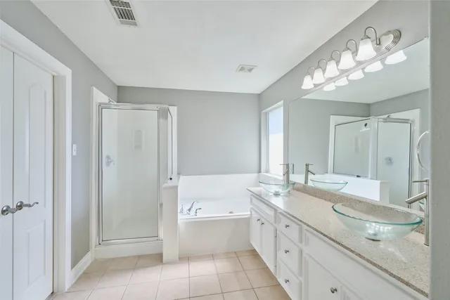 a bathroom with a double vanity sink and mirror with shower