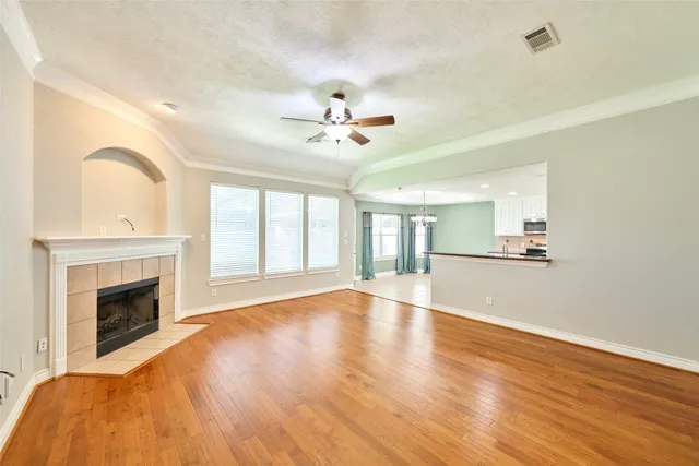 a view of a hallway with wooden floor and a window