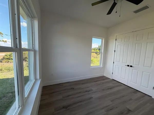 a view of an entryway with wooden floor and windows