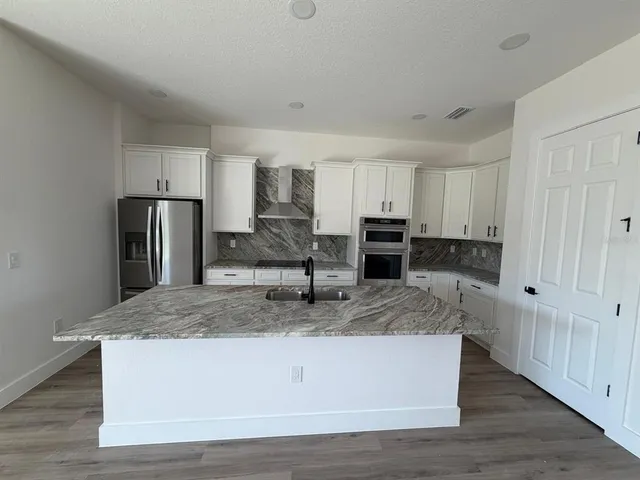 a view of a kitchen counter space stainless steel appliances