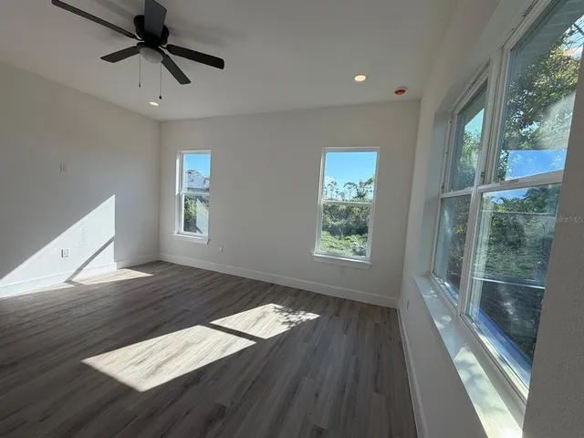 a view of wooden floor and windows in a room