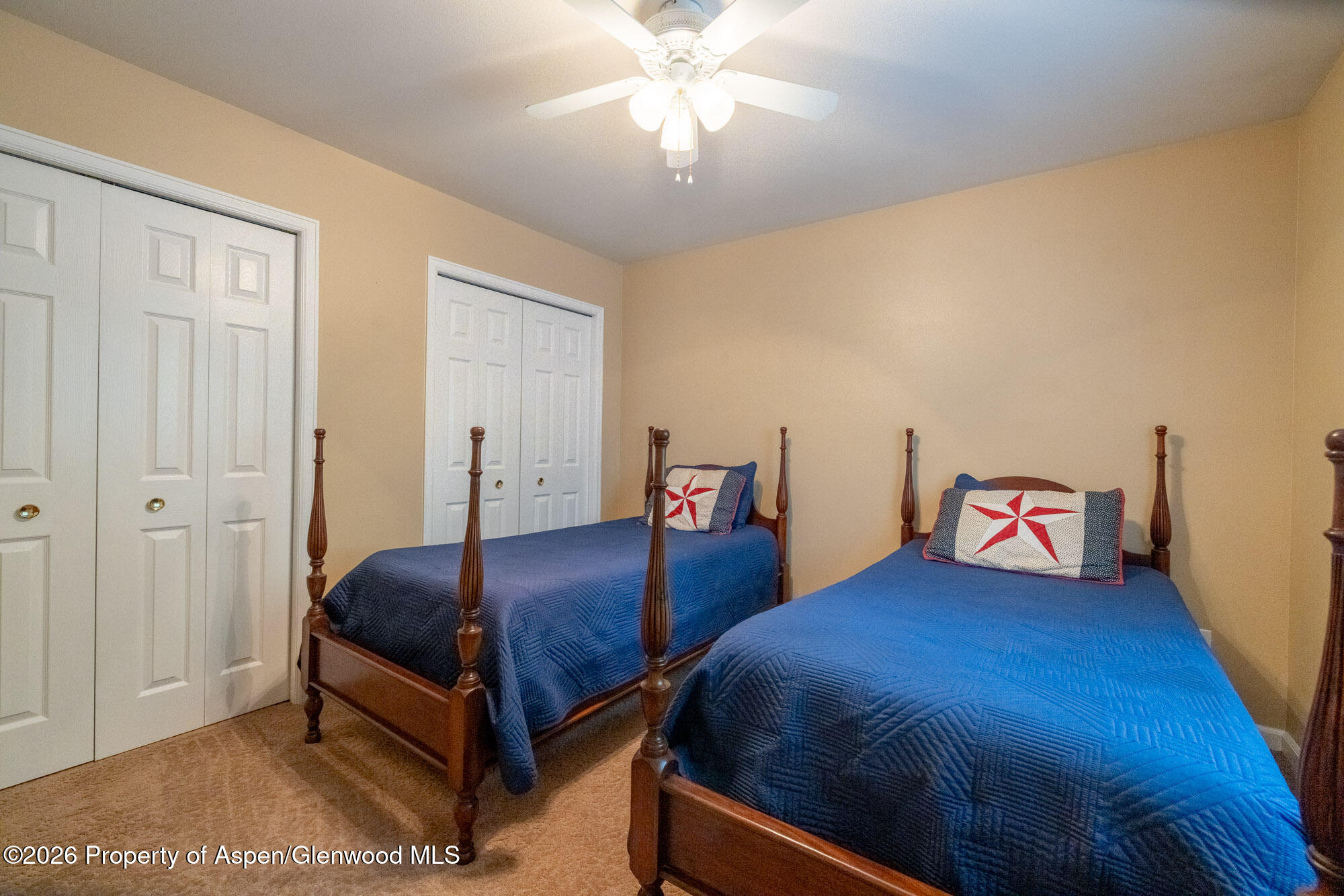 1335 Firethorn Drive Rifle, CO 81650 - Photo 17 of 30 a bedroom with two beds and a chandelier