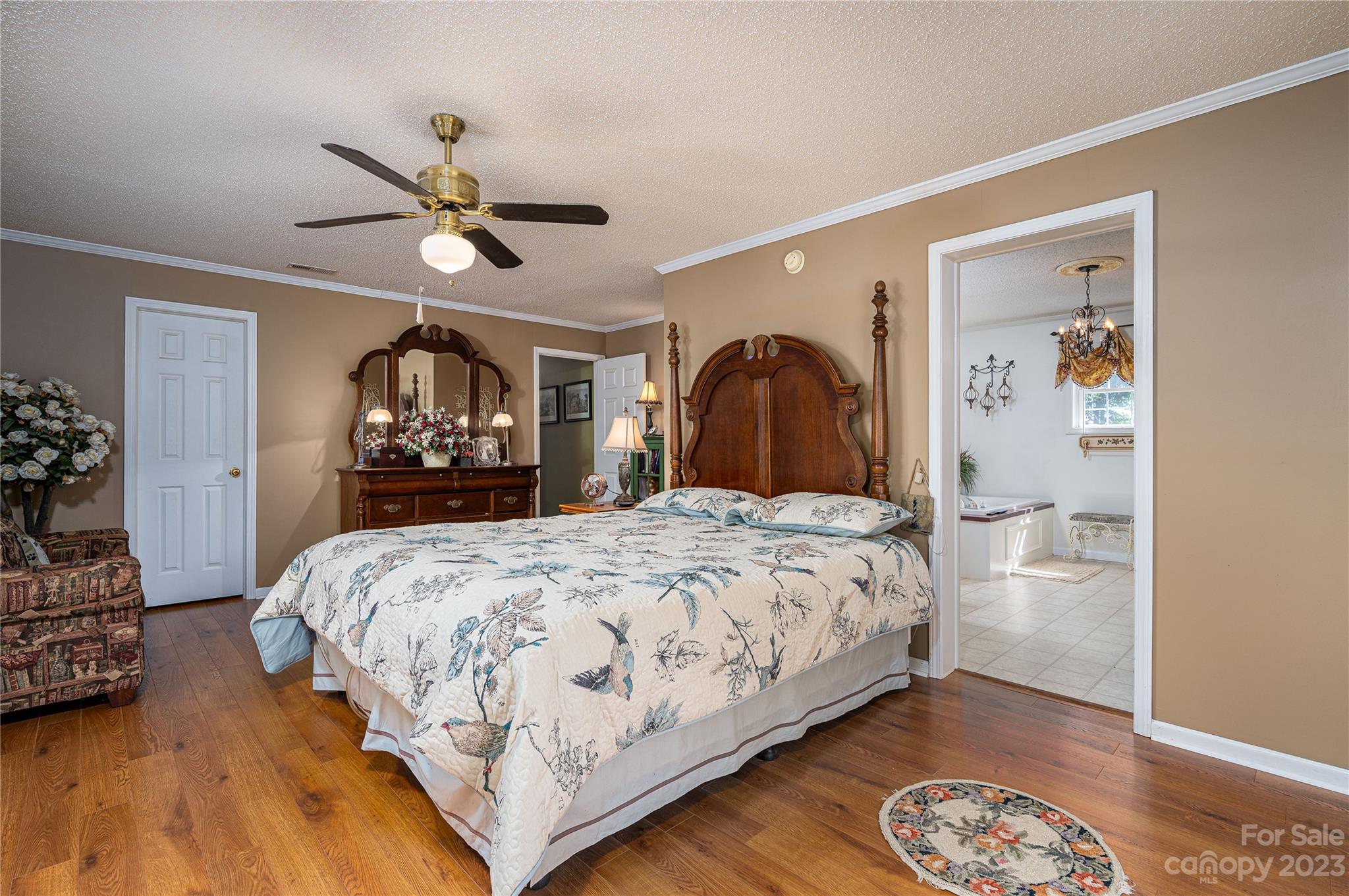 1575 Lewis Farm Road Kings Mountain, NC 28086 - Photo 16 of 42 a bedroom with a large bed and a chandelier