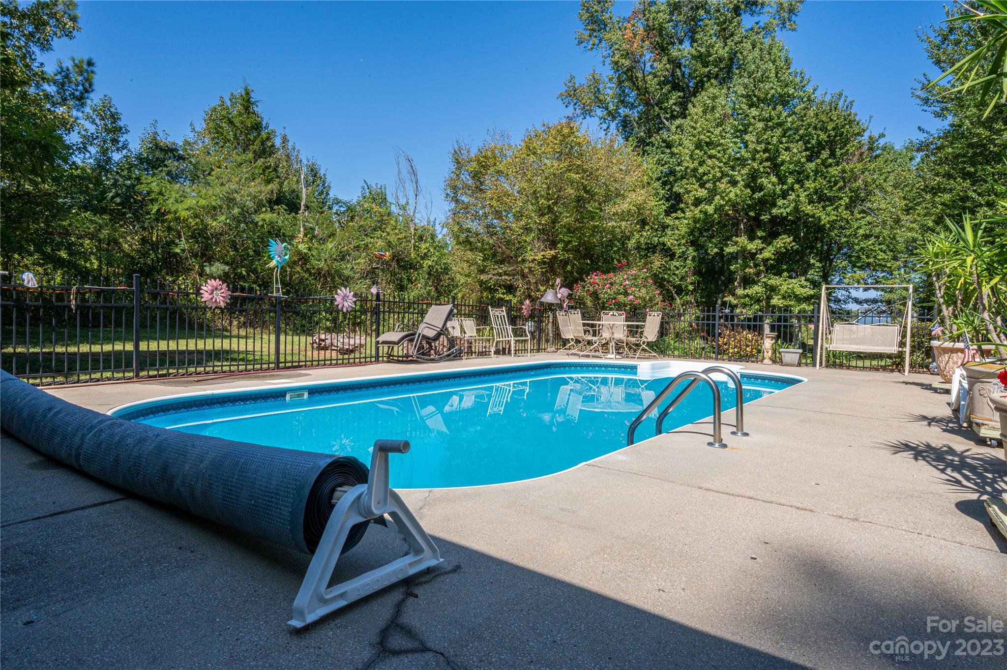 1575 Lewis Farm Road Kings Mountain, NC 28086 - Photo 31 of 42 a view of a pool with a bench and trees in the background