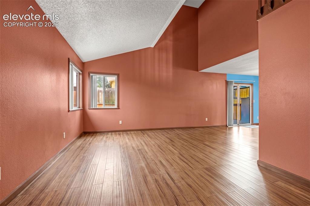 613 Wheat Field Road Fountain, CO 80817 - Photo 3 of 32 a view of an empty room with wooden floor and a window