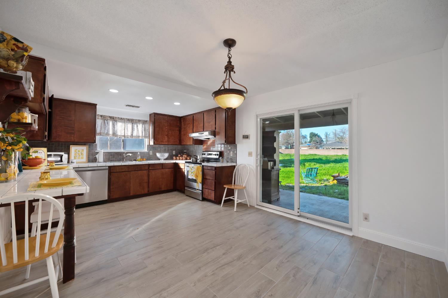 4271 Soledad Avenue Sacramento, CA 95820 - Photo 12 of 36 a kitchen with stainless steel appliances a stove a sink a center island and a window