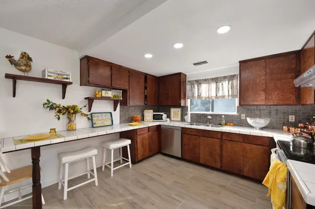 a kitchen with sink cabinets and wooden floor