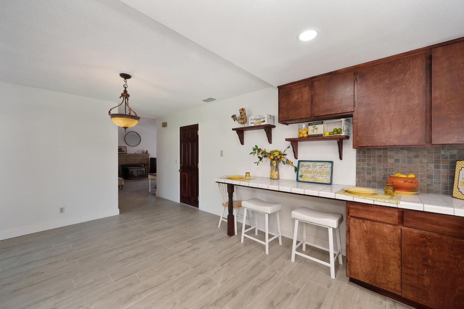 4271 Soledad Avenue Sacramento, CA 95820 - Photo 15 of 36 a kitchen with cabinets a sink and chairs in it