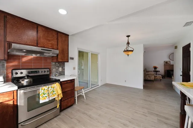 a kitchen with stainless steel appliances granite countertop a stove a refrigerator and a microwave