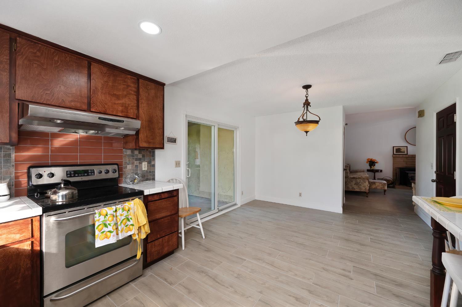 4271 Soledad Avenue Sacramento, CA 95820 - Photo 16 of 36 a kitchen with stainless steel appliances granite countertop a stove a refrigerator and a microwave
