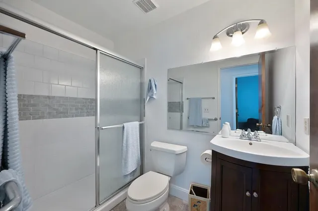 a bathroom with a sink toilet and shower