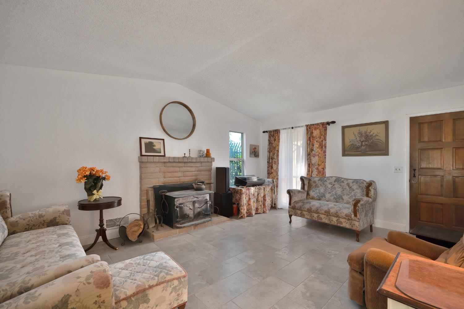 4271 Soledad Avenue Sacramento, CA 95820 - Photo 8 of 36 a living room with furniture and a fireplace