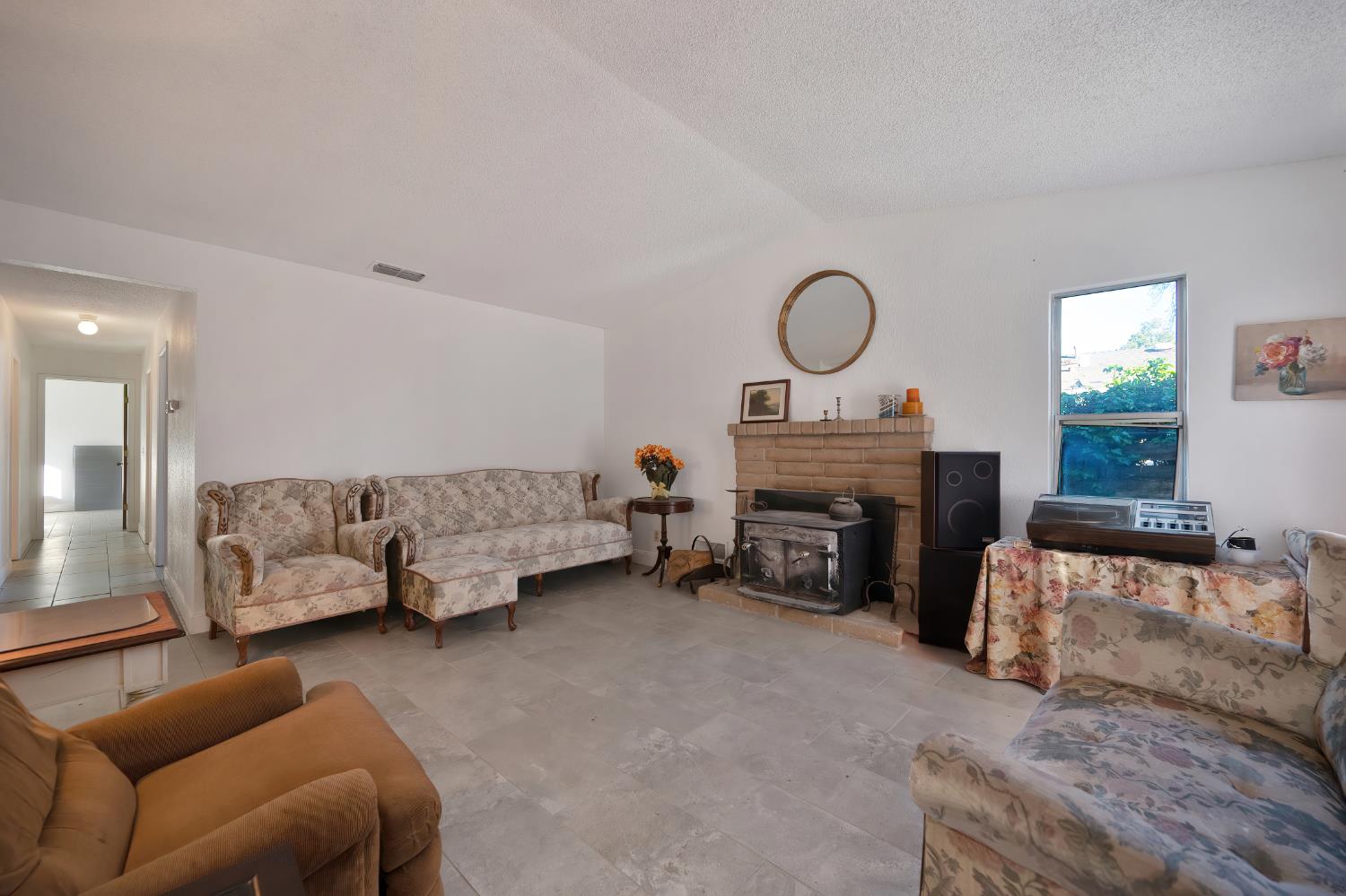 4271 Soledad Avenue Sacramento, CA 95820 - Photo 9 of 36 a living room with furniture and a fireplace