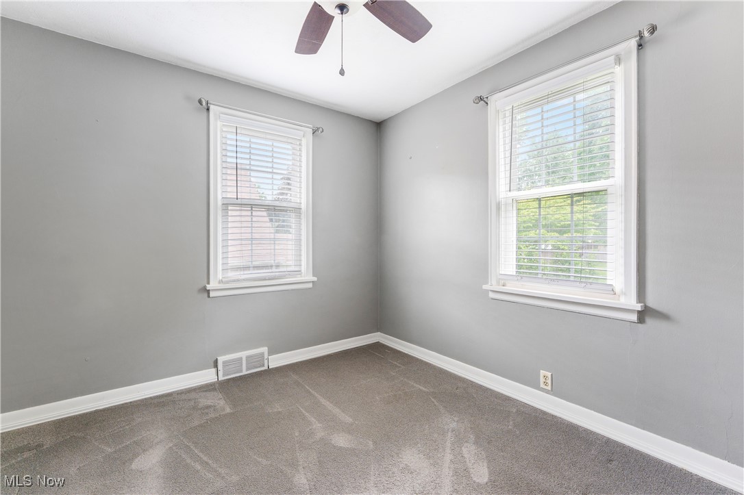 1703 Ferndale Road Northwest Canton, OH 44709 - Photo 12 of 34 Carpeted empty room with healthy amount of natural light and a ceiling fan