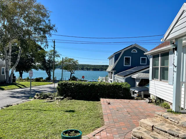a view of a house with backyard and sitting area