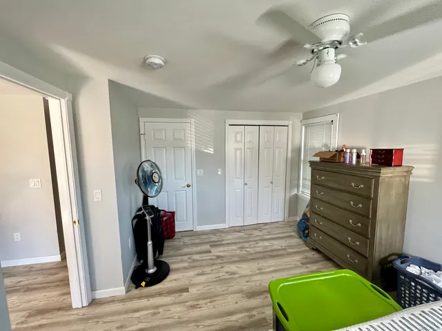 a living room with furniture and a dresser