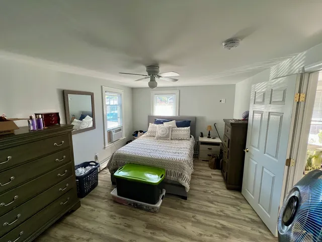 a room with a bed window and a mirror