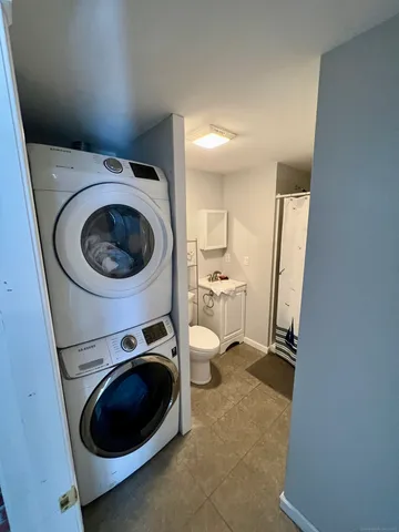 a utility room with sink dryer and washer