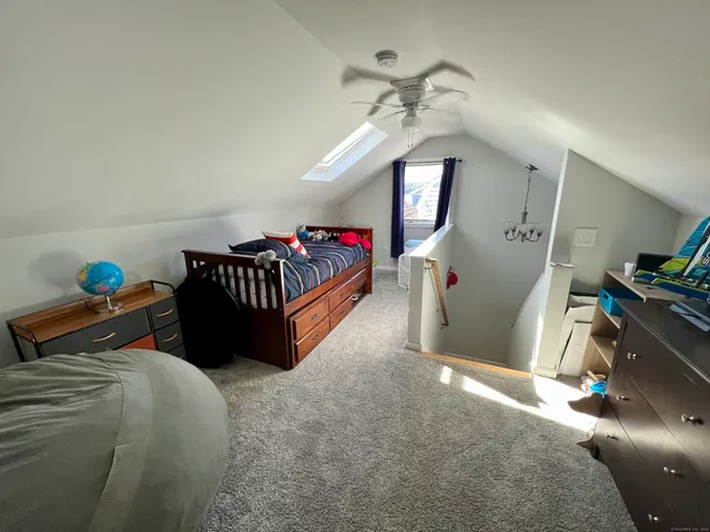 a bed room with a bed and a chandelier