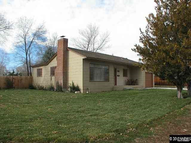 695 Robin Street Reno, NV 89509 - Photo 1 of 1 a house that is sitting in the grass with trees